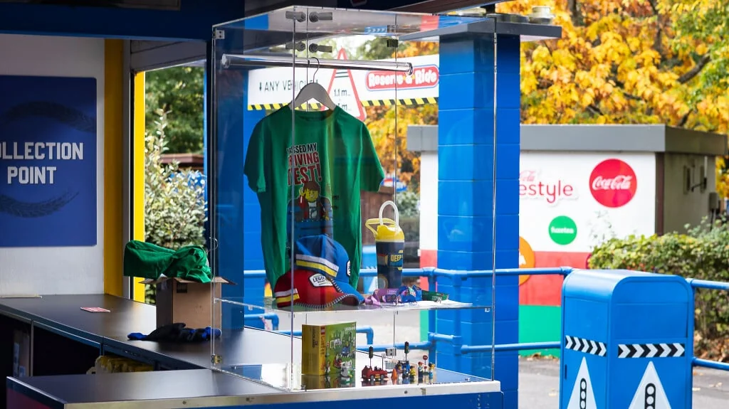 Lockable BOXXCO counter case at LEGOLAND Windsor holding a T-shirt, caps, cups and boxed sets